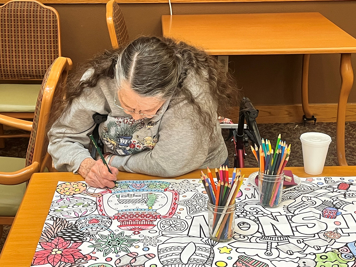 woman coloring on giant coloring book