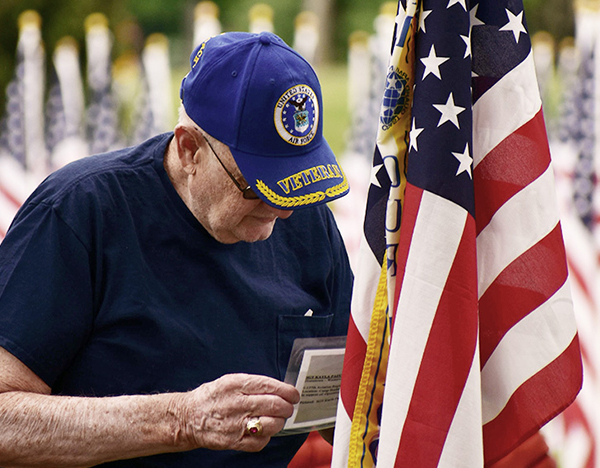 older veteran man looking at flag